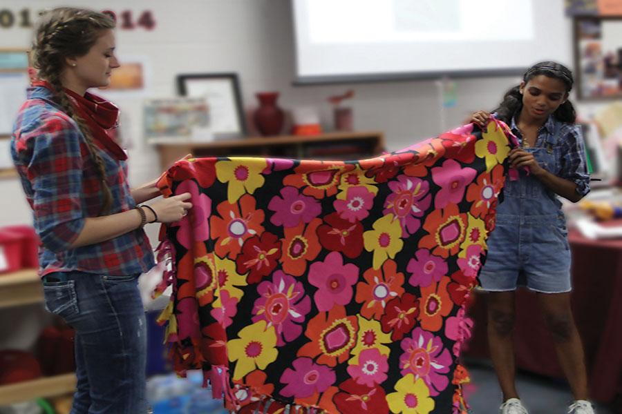 Williams and Seidl presenting a blanket to  the linus club 