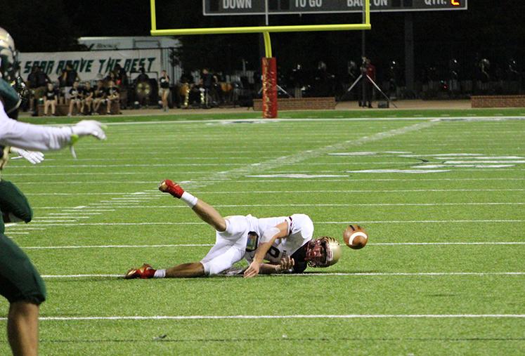 Powers attempts to get a ball off before taking a sack