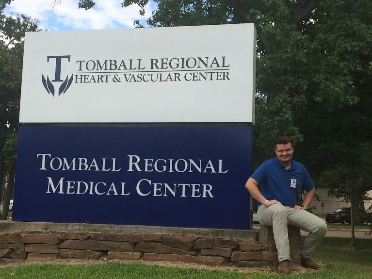 Garrett+Henry+sitting+in+front+of+the+Tomball+regional+hospital+sign.+