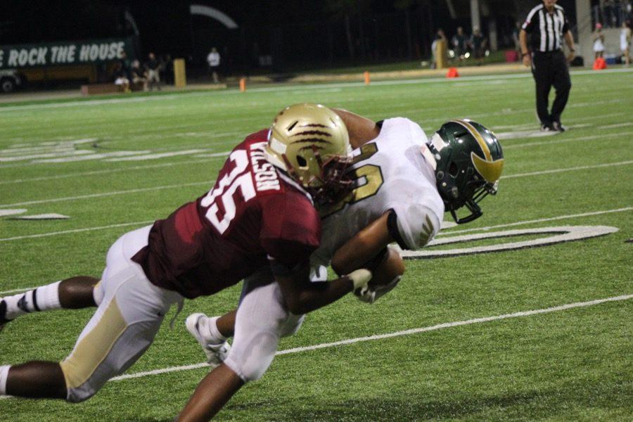 Myles Wilson dives to demolishes a Cy Falls receiver. Photo by Matt Ramos.