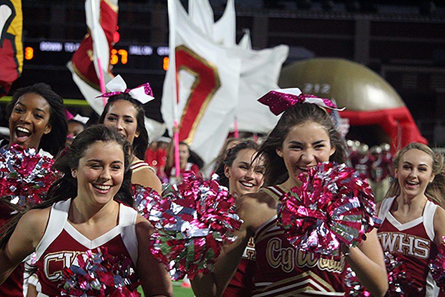 Cy Woods Cheerleaders running out at the Homecoming game.