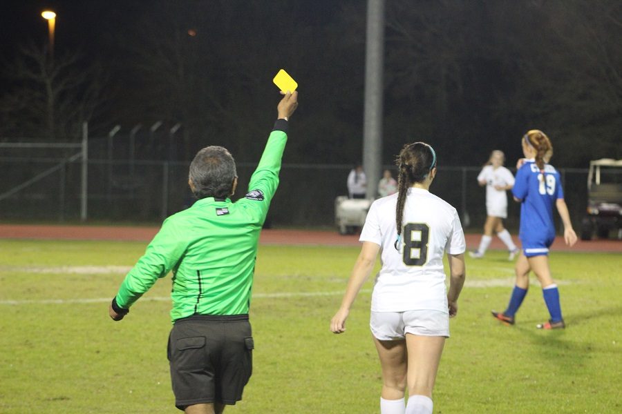 Lexi Fowler being sent off the field with a yellow card.