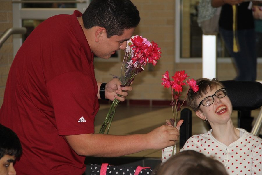 Passing out flowers and spreading smiles.