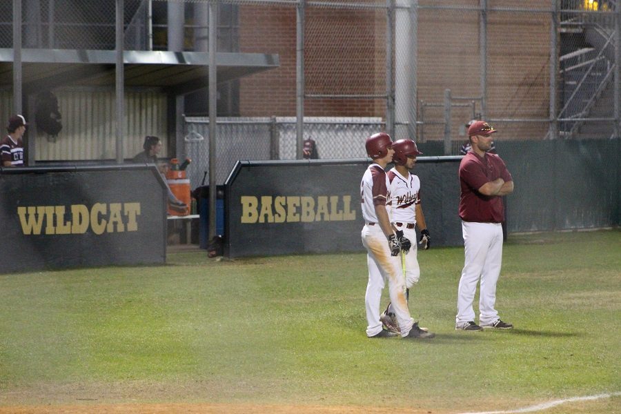 Two Wildcats stand with Head Coach Kipp Pridgeon while Cy-Fair changes pitchers.