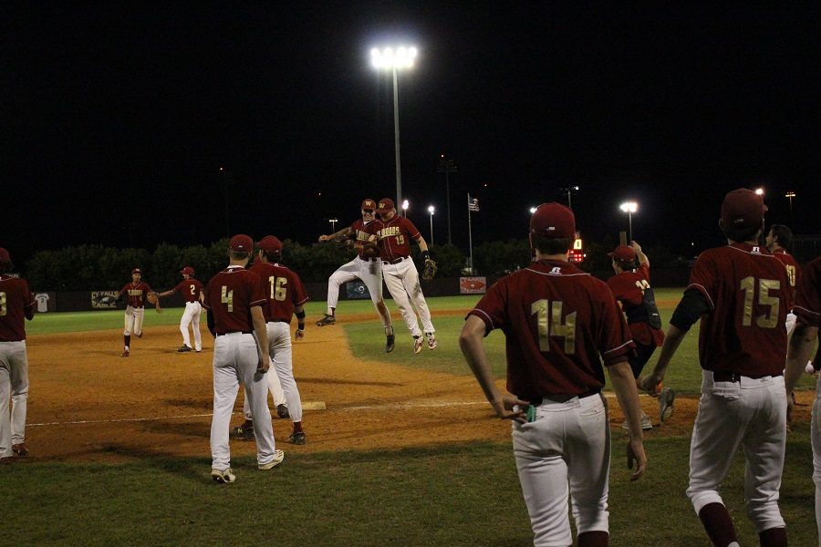 Seniors Zach McAdams and Garrett Kellogg-Clarke jump in celebration after beating district rival Cy-Fair 6-5