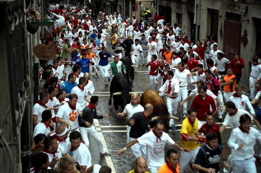 Participants run through the streets of Spain during the Running of the Bulls festival.