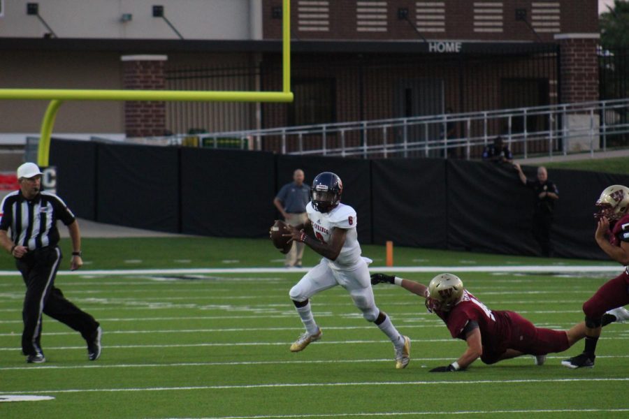 Defender Clancey Hall attempts to tackle the Cy Springs Quarterback.