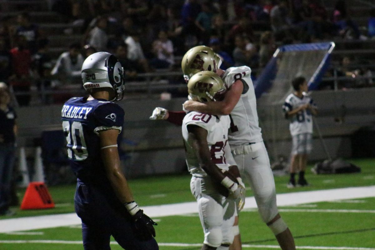 Running Back Cullen Sherill congratulates Wide Receiver Arkievrick Vitatoe after scoring a touchdown in the fourth quarter.