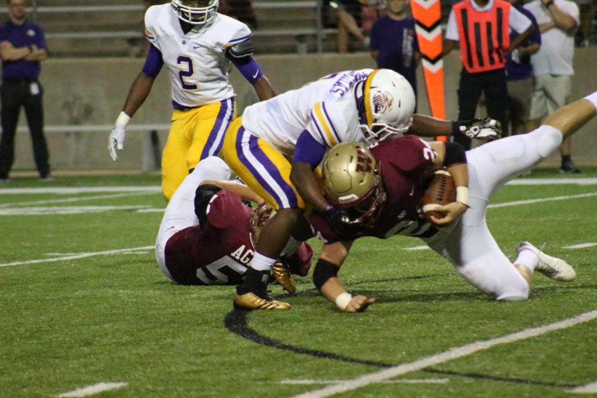 Running back Bobby Dodson goes down with the ball during the first half of the game against Jersey Village.