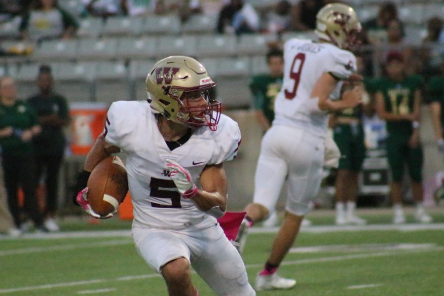 Running back Jack Barrientez runs with the ball during the first quarter.