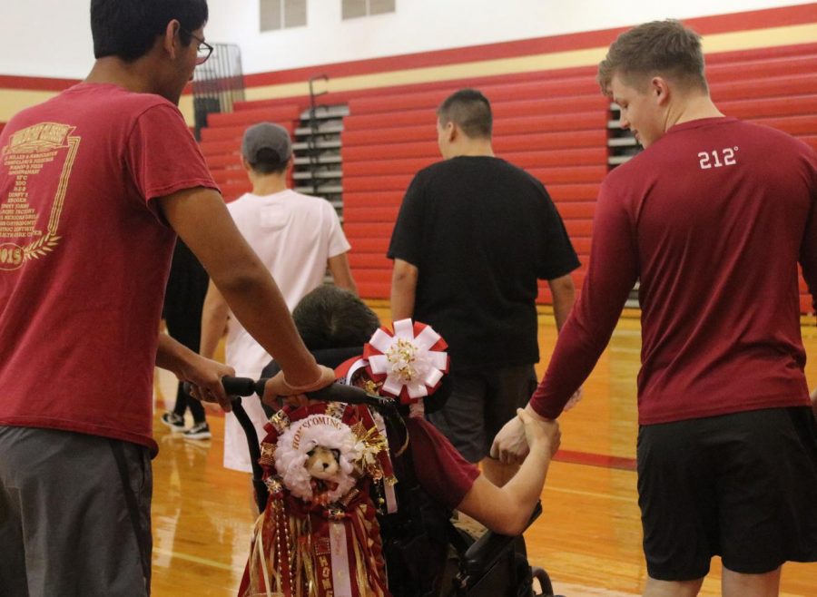 Senior Chakra Jonnalagadda pushes sophomore  Austin Matheson while he holds senior Peyton Dunmans hand. 