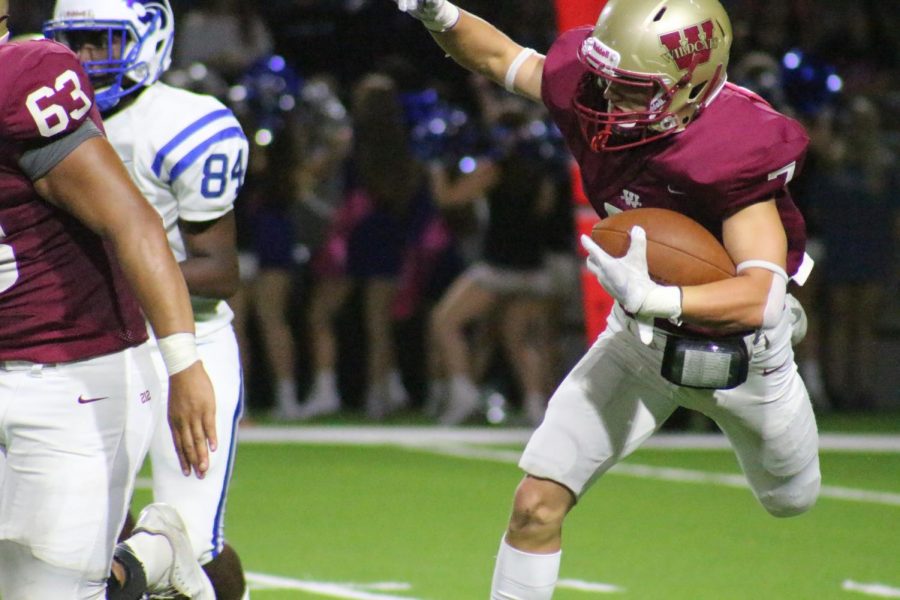Wide receiver Jacob Tesch lands after leaping to avoid a Cy Creek defender during the third quarter.