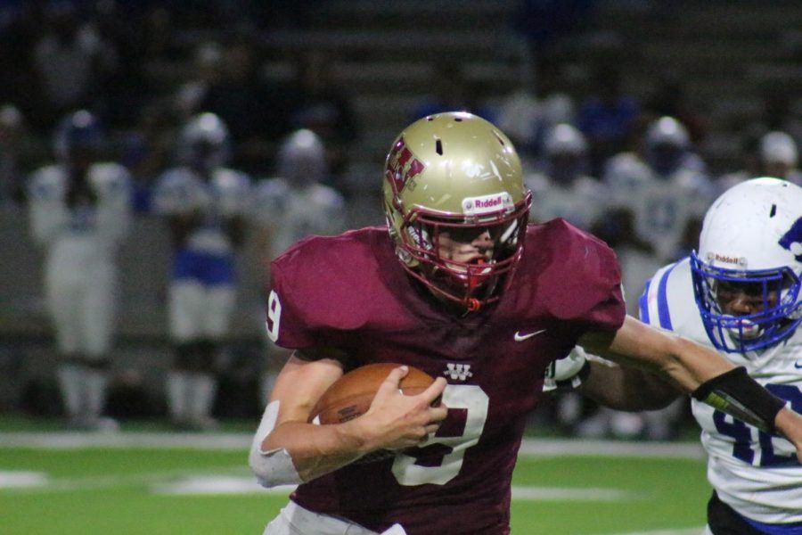 Quarterback Jackson Jones attempts to keep a Cy Creek defender off of him as he protects the ball during the third quarter.