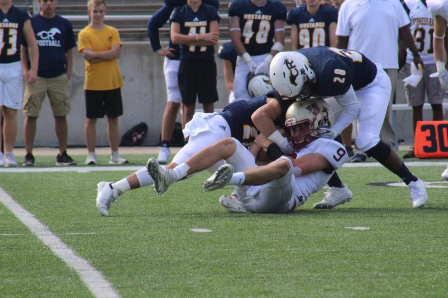 Quarterback Jackson Jones is sacked by two Cy Ranch defenders during the second quarter.