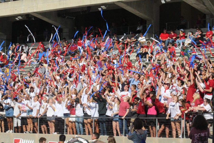 The student sections throws red, white and blue streamers into the air during the third quarter.