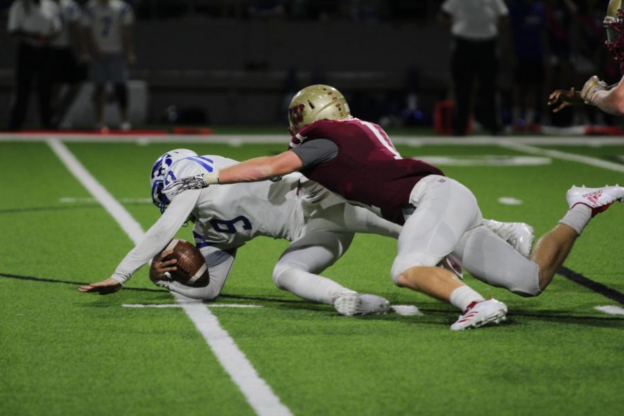 A Cy Woods defender sacks the Cy Creek quarterback during the second quarter of the Cy Creek game.