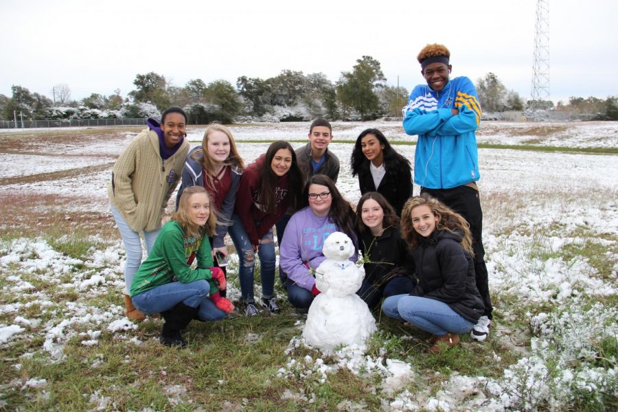 Journalism1 class poses with their snowman.