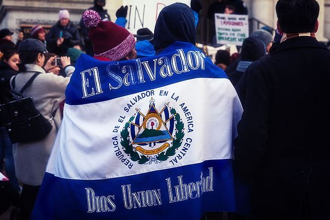 Protesters walk with an El Salvador flag banner during the Day Without Immigrants strike in May 2017. 