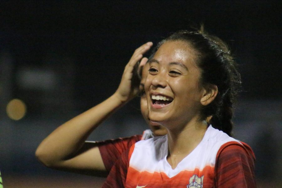 Senior Yasmine Cuadra laughs while celebrating with her teammates after beating the Cy Creek Cougars 5-1.