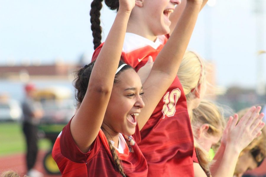 Sophomore Kiran Singh celebrates with her teammates after a Cy Woods goal during the game against the Cy Springs Panthers.