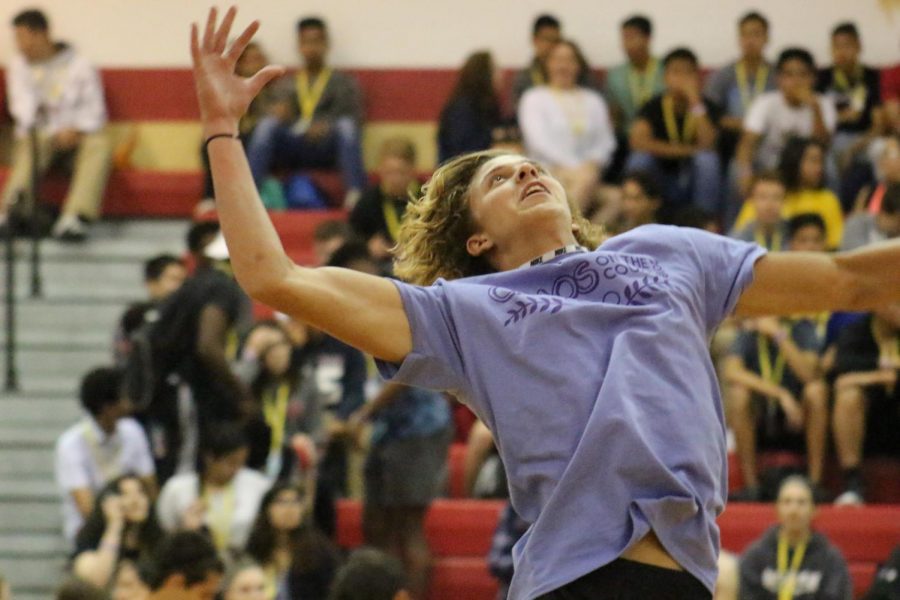 Senior Jared Swonke jumps up to hit a volleyball during warm-ups before Chaos on the Court.