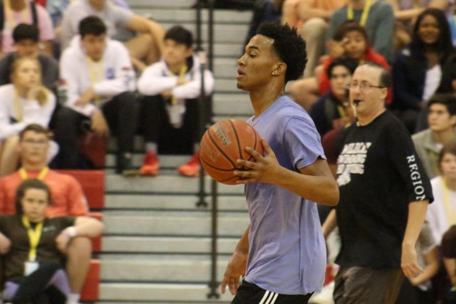 Senior Jarrid Smith dribbles the ball as he makes his way down the court during the basketball portion.