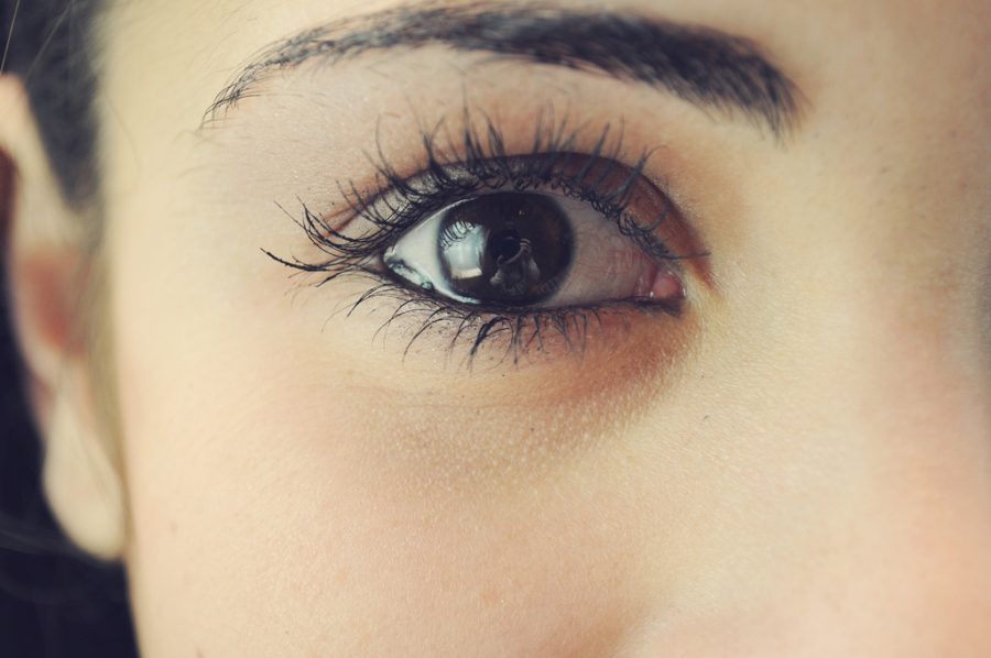 A girl with mascara on her eye lashes.