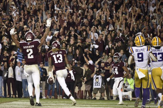 Jhamon Ausbon and Kendrick Rogers celebrate when the Aggies pulled off the victory.