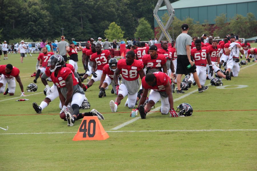 Atlanta Falcon players stretch before practice. 