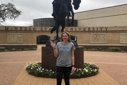 Hines standing in front of McNeese University