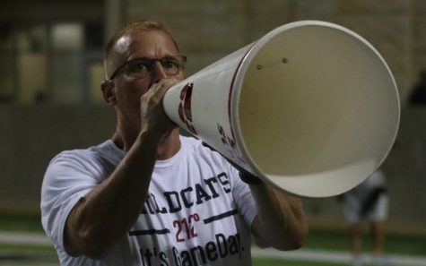 Associate Principal Dirk Heath rallies the crowd with the use of a megaphone at varsity football game against Cy-Ridge on September 27