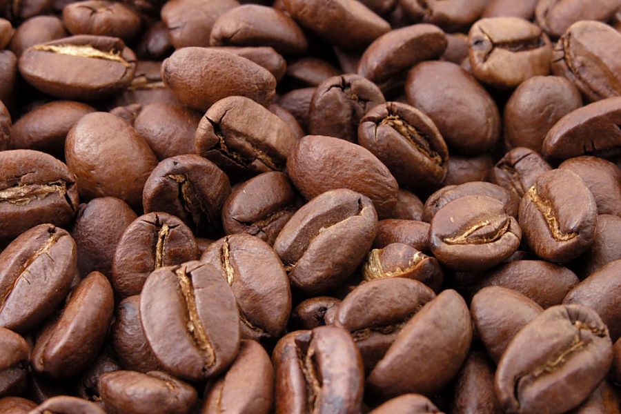 Scattered coffee beans on a table.