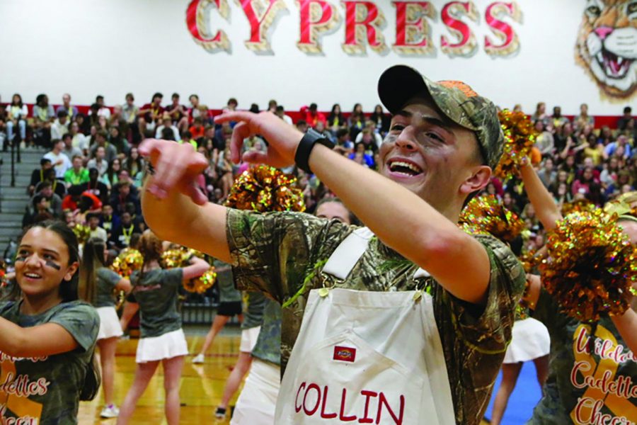 Senior Collin Bass dances at the Camo parade at Cy- Woods on September 6.