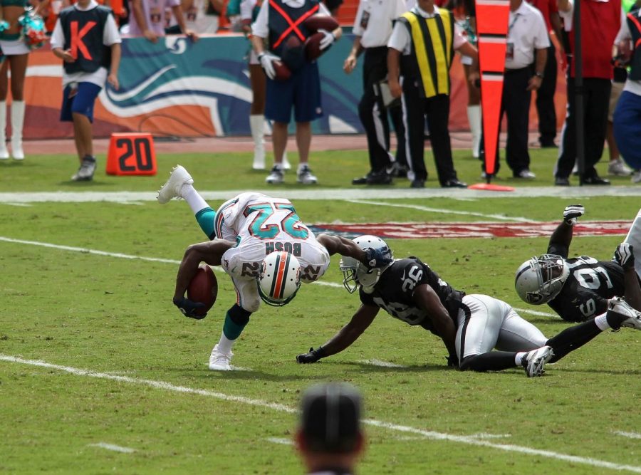 Oakland Raiders defender tackles Miami Dolphins running back Reggie Bush on September 16, 2012