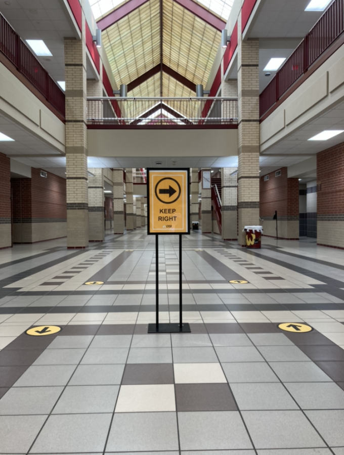 Signs directing hallway traffic.
