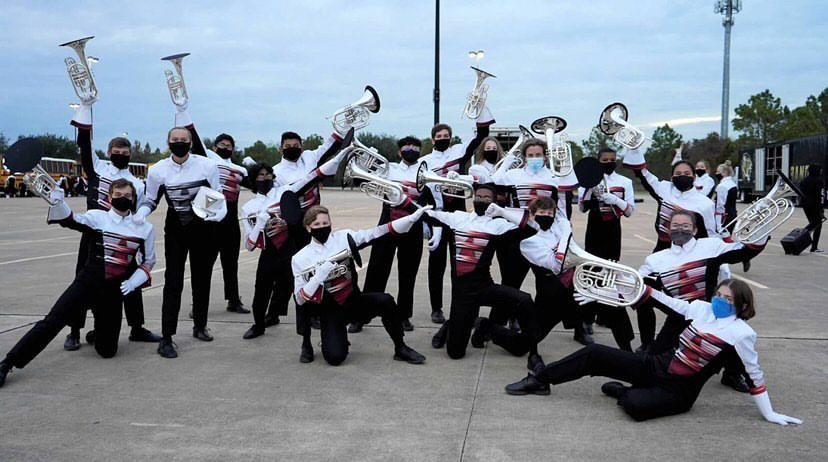 Members of the french horn section pose together following the confirmation of their eligibility at state. 