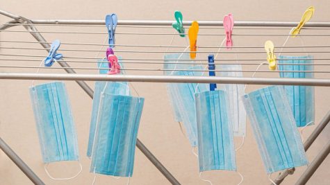 Medical masks hang on a dryer with clothespins by wuestenigel is licensed under CC BY 2.0
