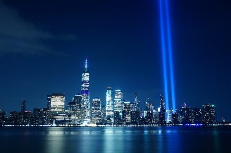 A blue light shines where the Twin Towers once stood.
