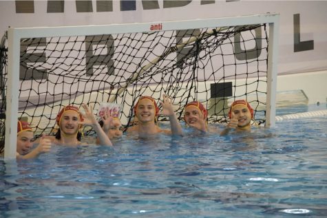 Xander McWhorter and the water polo team at the CFISD Natatorium