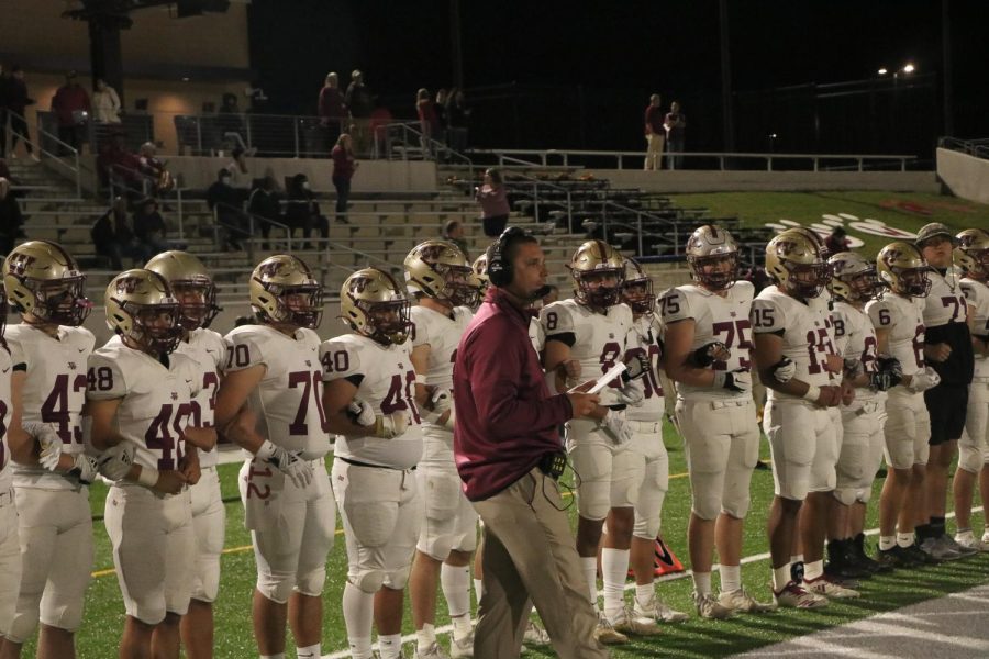 Players stand at attention to the pre game coin toss