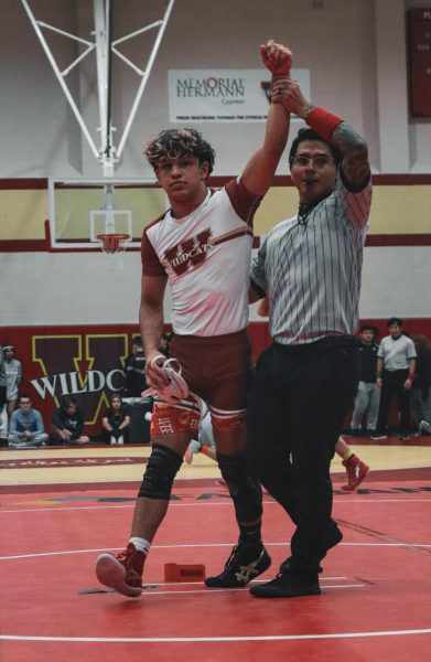 During the Battle at the Woods, an official raises junior Collin Tingley's, indicating he won the match.