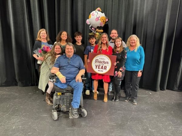 Social studies teacher Alicia Montes takes a photo with her family after being named the campus Teacher of the Year.