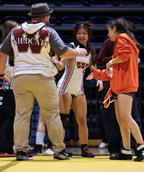 At the district tournament, junior Kelsey Tran celebrates with the sidelines after winning a round. Tran moved on to the regional tournament.