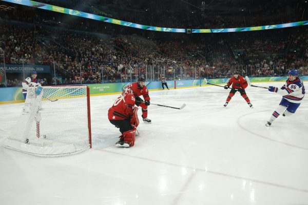 Feb 22, 2026; Milan, Italy; Jack Hughes #86 of Team United States scores the golden goal on Jordan Binnington #50 of Team Canada in overtime during the Milano Cortina 2026 Olympic Winter Games at Milano Santagiulia Ice Hockey Arena. Mandatory Credit: Geoff Burke-Imagn Images
