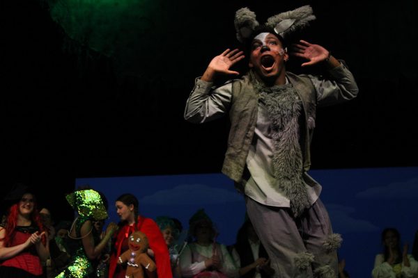 During bows, senior Seleven Raven listens to the cheers. Raven played Donkey during this performance.