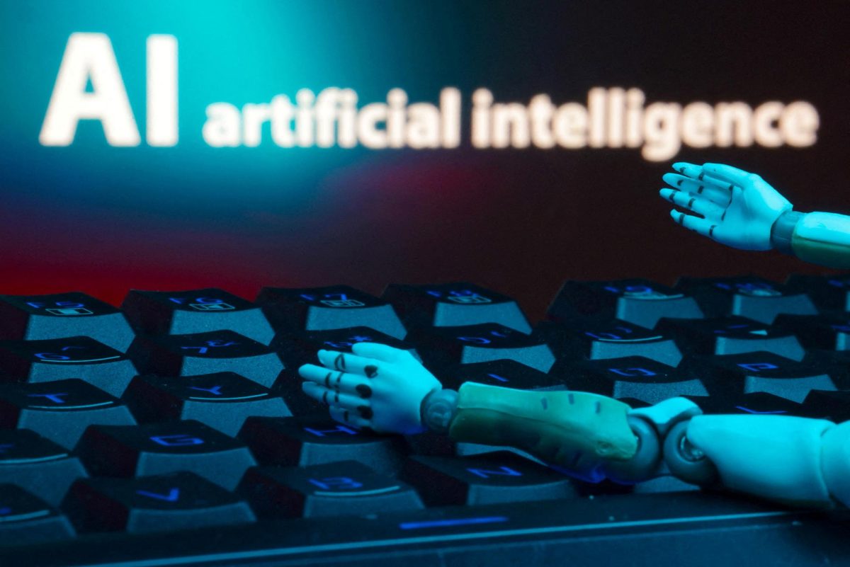 A message reading "AI artificial intelligence", a keyboard, and robot hands are seen in this illustration taken January 27, 2025. REUTERS/Dado Ruvic/Illustration