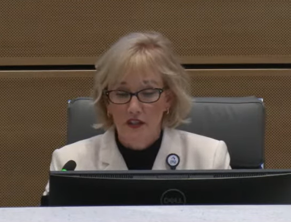 During a February board work session, board president Julie Hinaman introduces an agenda item to restore access to textbook chapters that were removed in 2024.